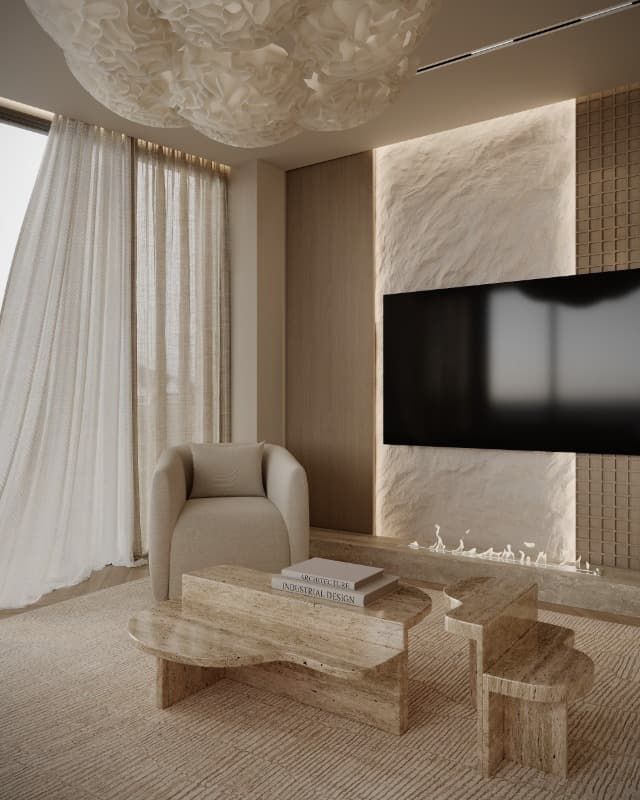 Una sala de estar con mesa de café, silla, televisión y chimenea.