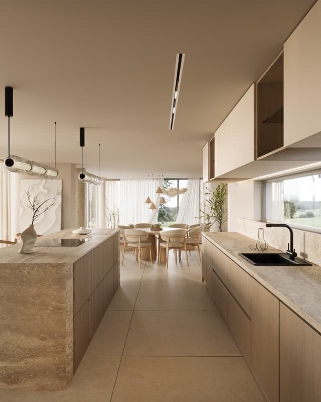 Una cocina con fregadero y un comedor al fondo.