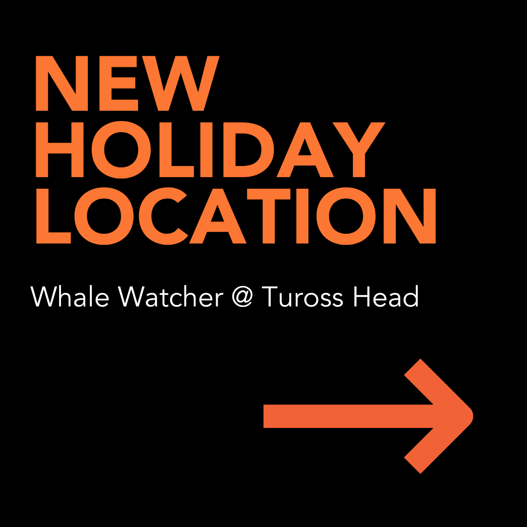 New holiday location sign for Whale Watcher at Tuross Head, with orange arrow on black background