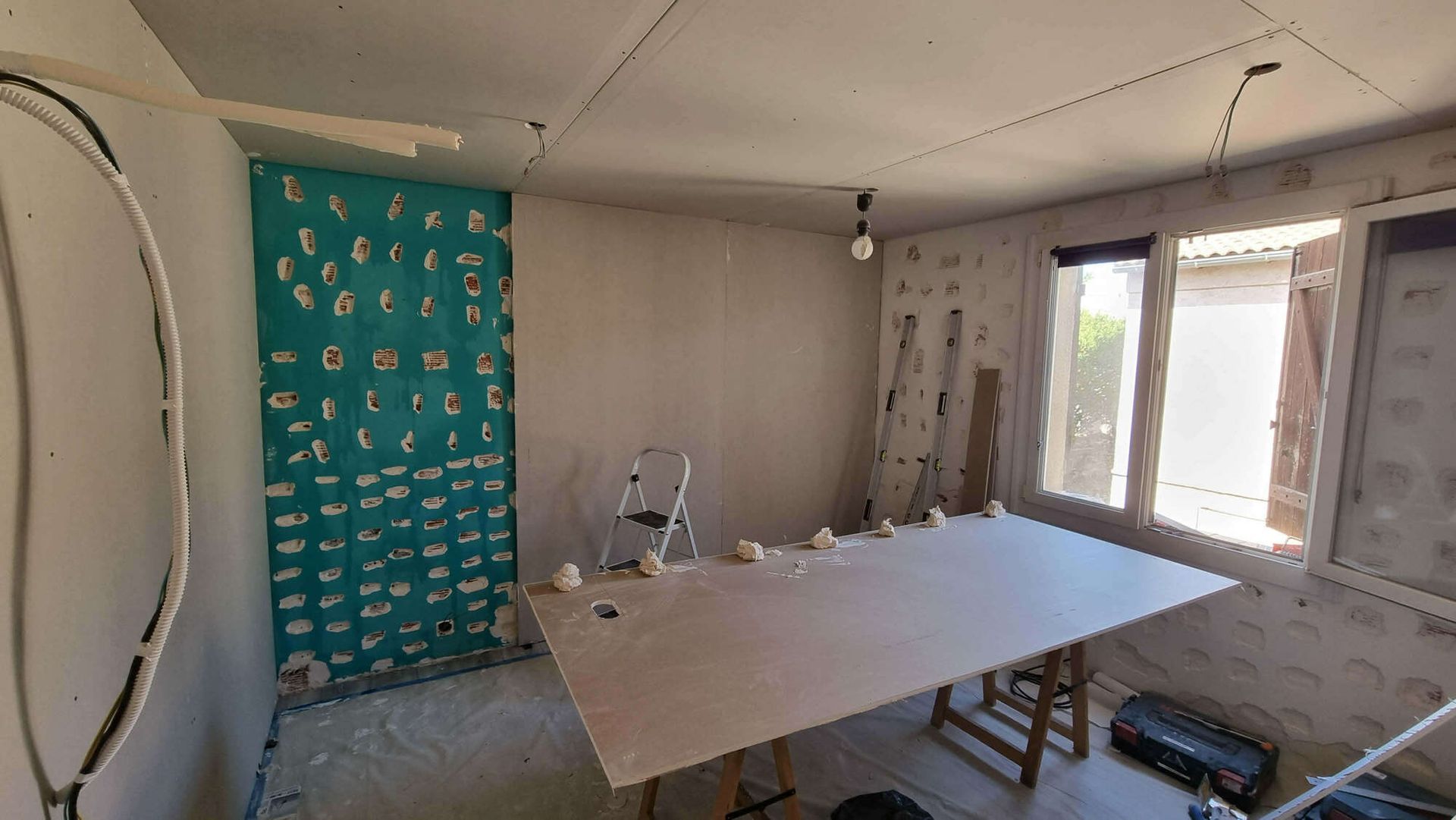 Une maison en rénovation avec des branchements électriques.