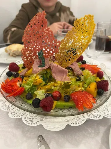Un primer plano de una ensalada en un plato sobre una mesa.