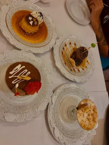 Hay cuatro platos de postres sobre una mesa.