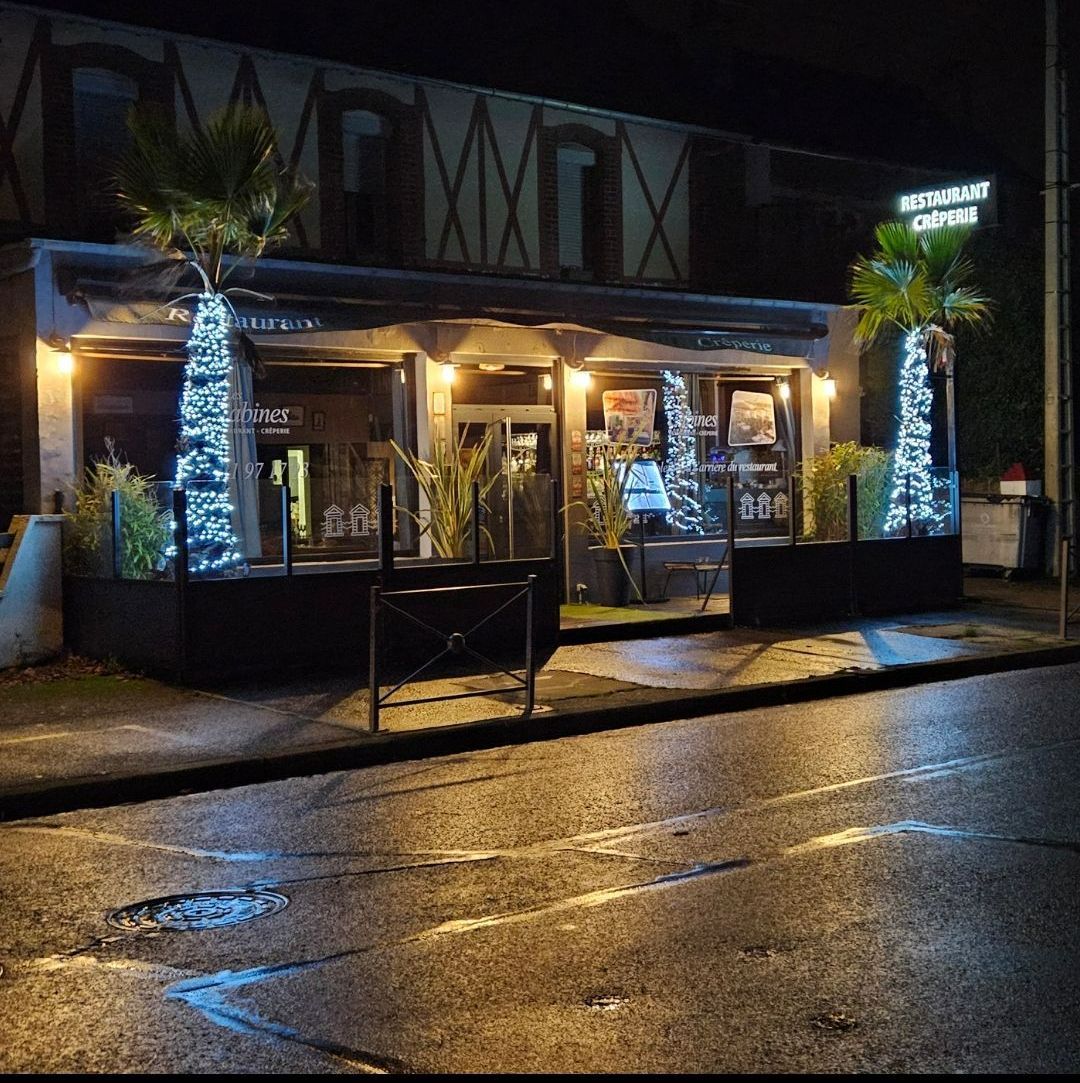 Vue nocturne de l’entrée de la crêperie Les Cabines à Ouistreham