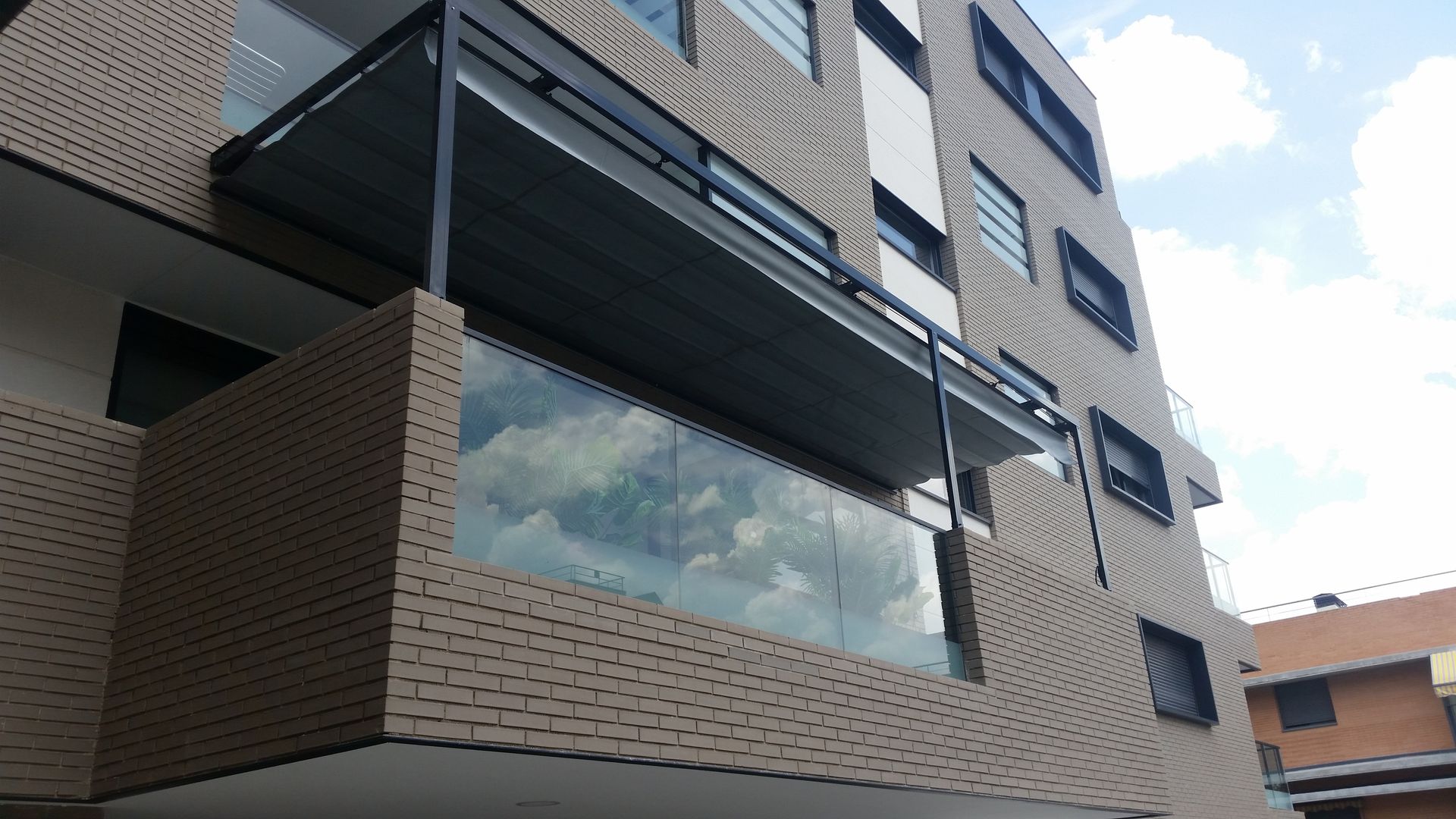 Un edificio con un balcón en el lateral.