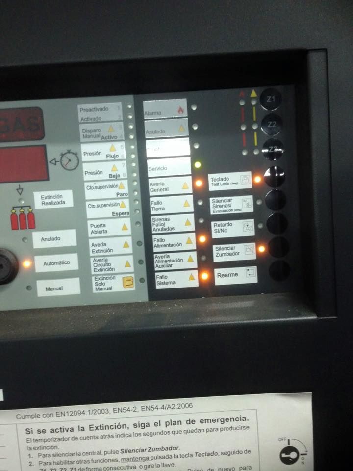 Un panel de control con muchos botones y un cartel que dice si se activa la emergencia