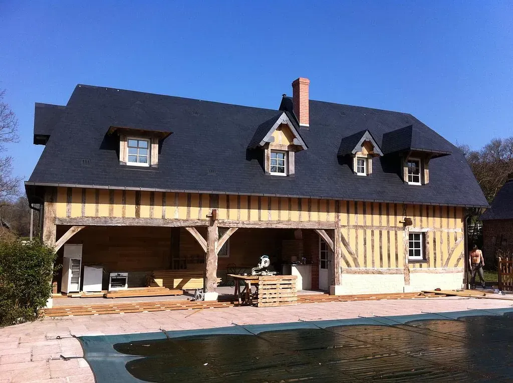 Maison avec toiture en ardoise et façade en colombages