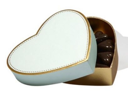 Eine herzförmige Schachtel mit Pralinen darin