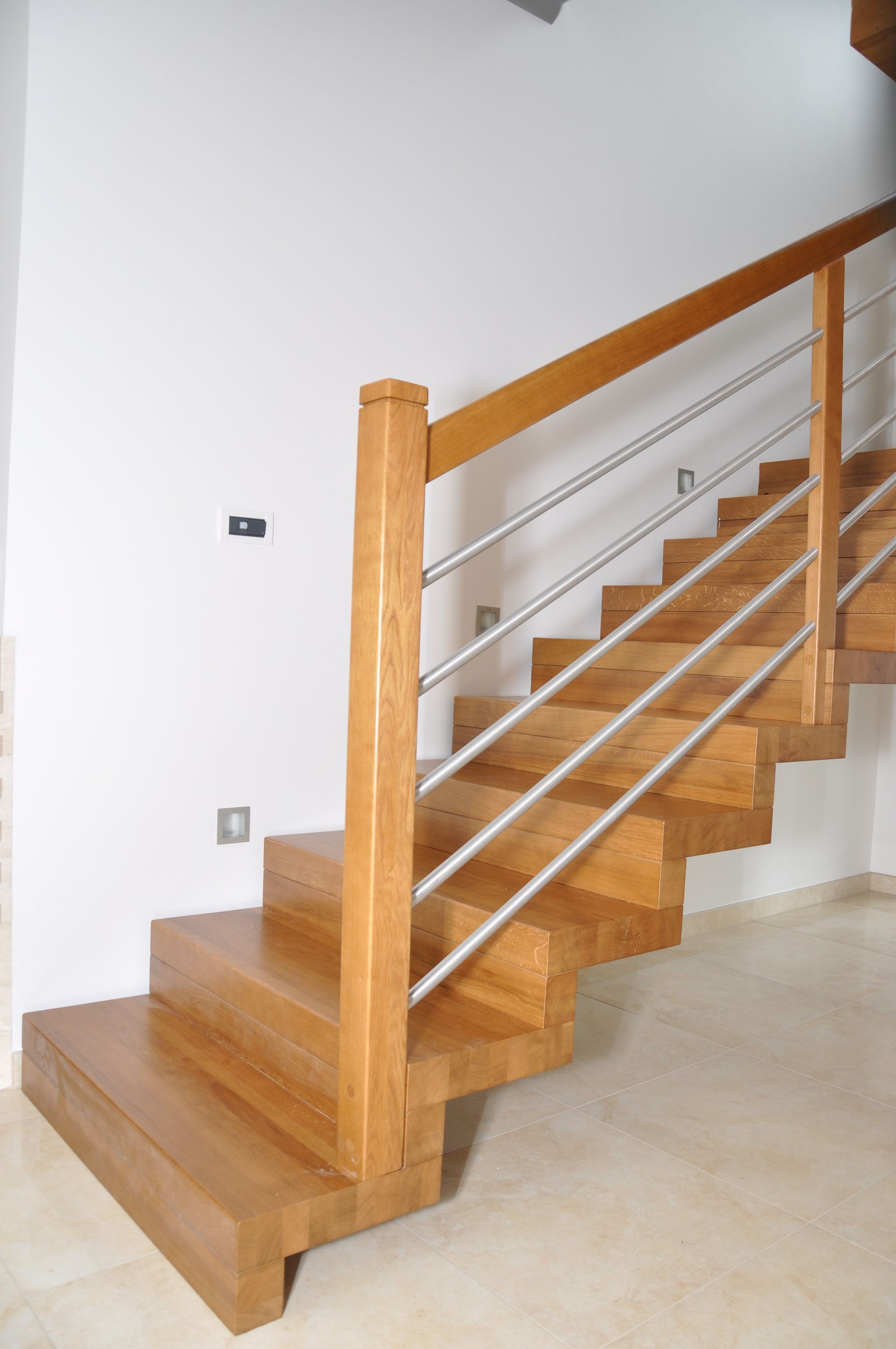 Eine Holztreppe mit Edelstahlgeländer