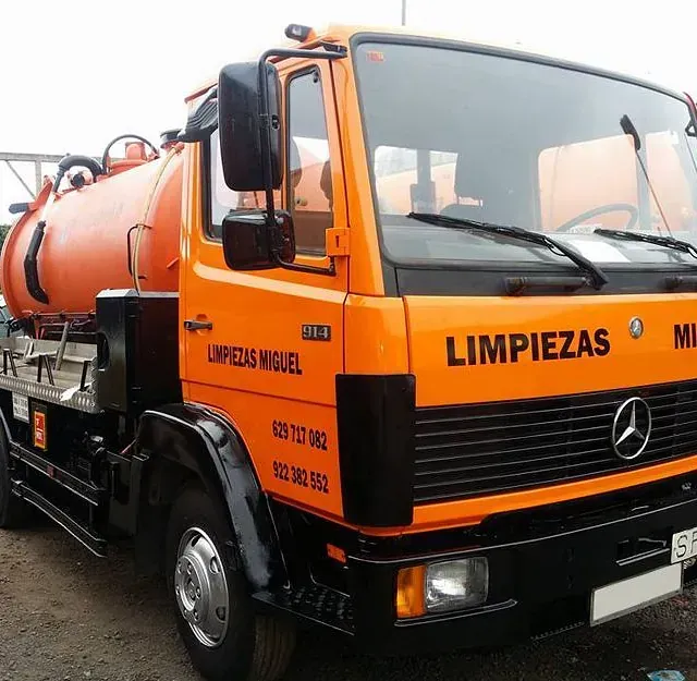 Un camión naranja que dice limpiezas en el frente