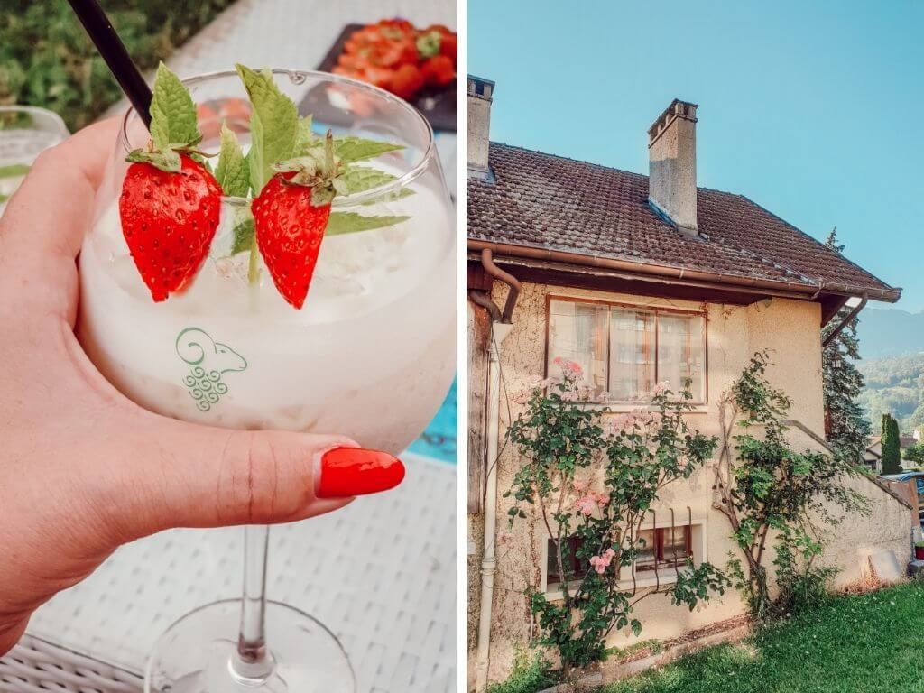Main tenant un cocktail à la fraise à côté d'un cottage rustique avec des vignes fleuries