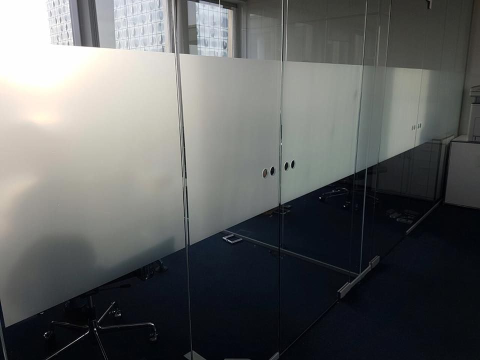 Ein Raum mit einer Glaswand und einem Stuhl darin.