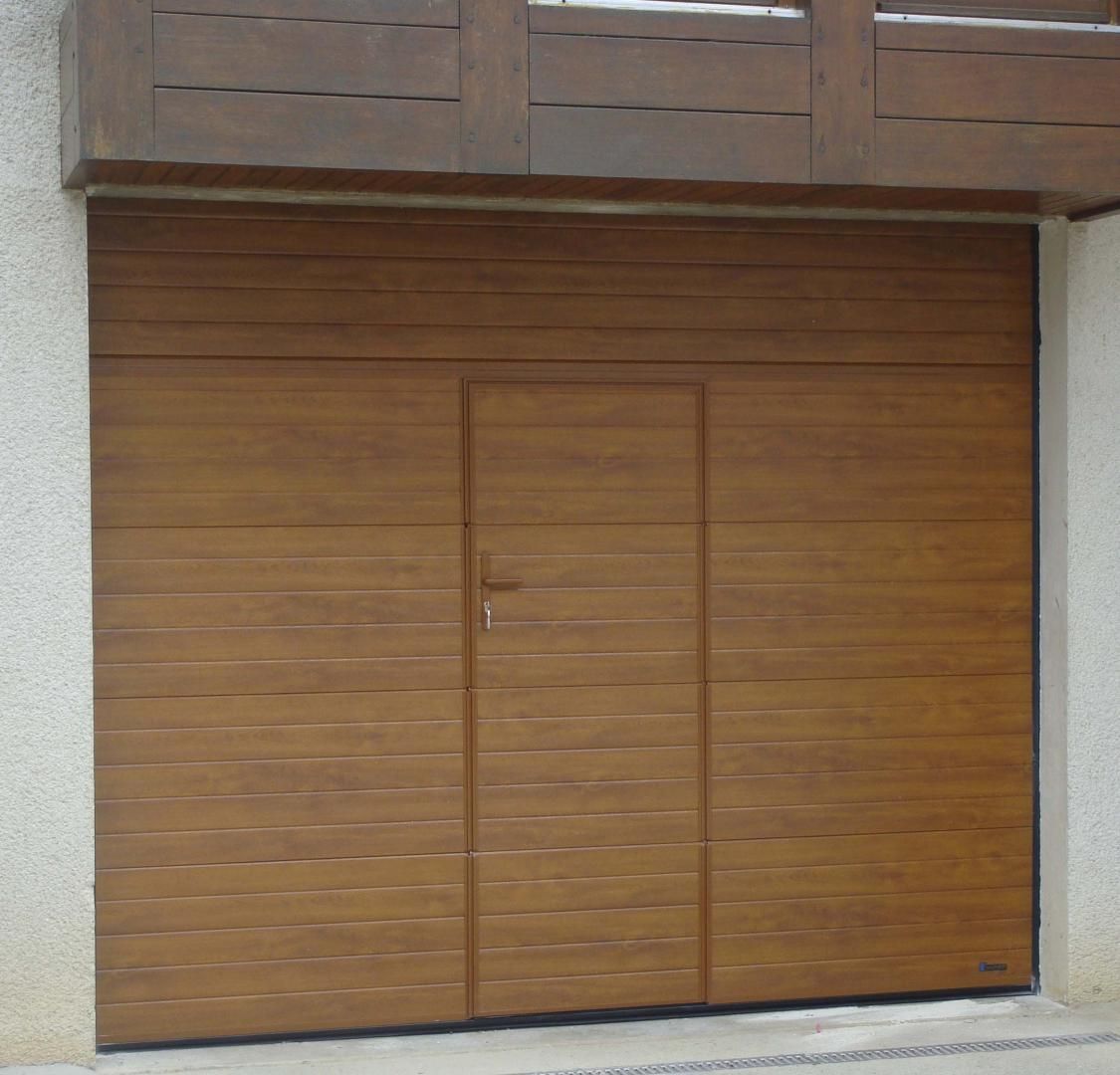 Porte de garage marron avec porte piétonne intégrée.