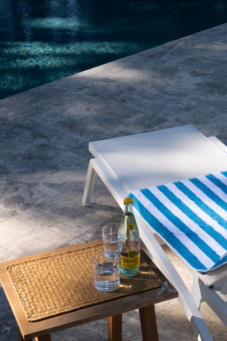 People toasting with drinks outdoors. Some drinks contain raspberries.
