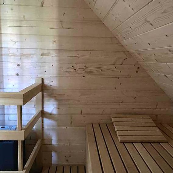 Eine Holzsauna mit Holzbank und Treppe.