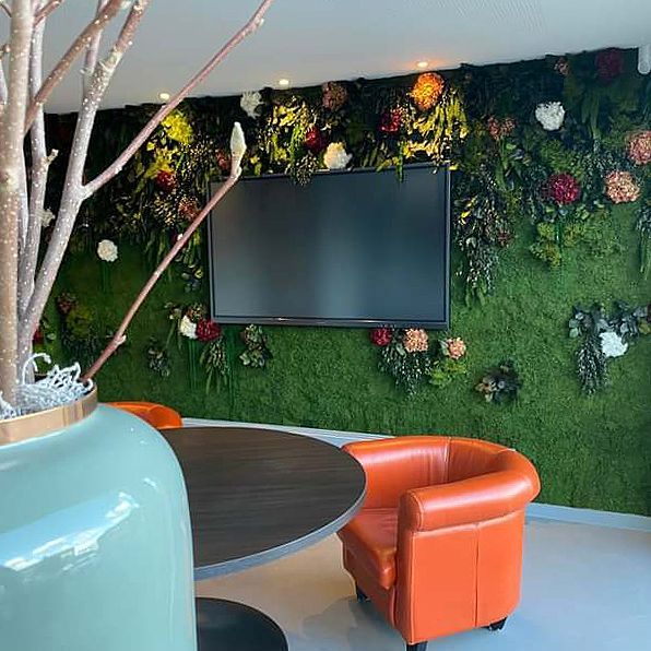 Ein Wohnzimmer mit Tisch und Stühlen und einem Fernseher an der Wand.