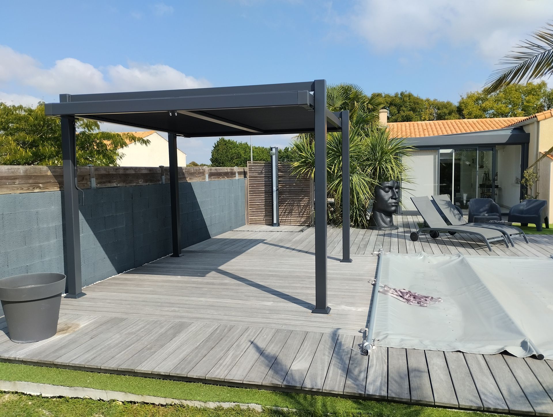 Une pergola en alu à côté d'une piscine