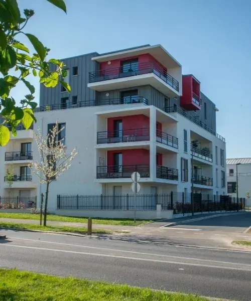 Un immeuble blanc, gris et rouge