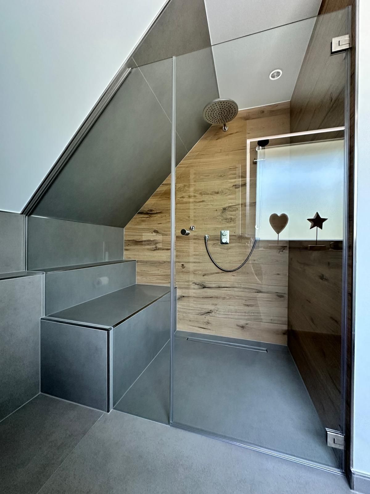 Ein Badezimmer mit ebenerdiger Dusche und einer Sitzbank.