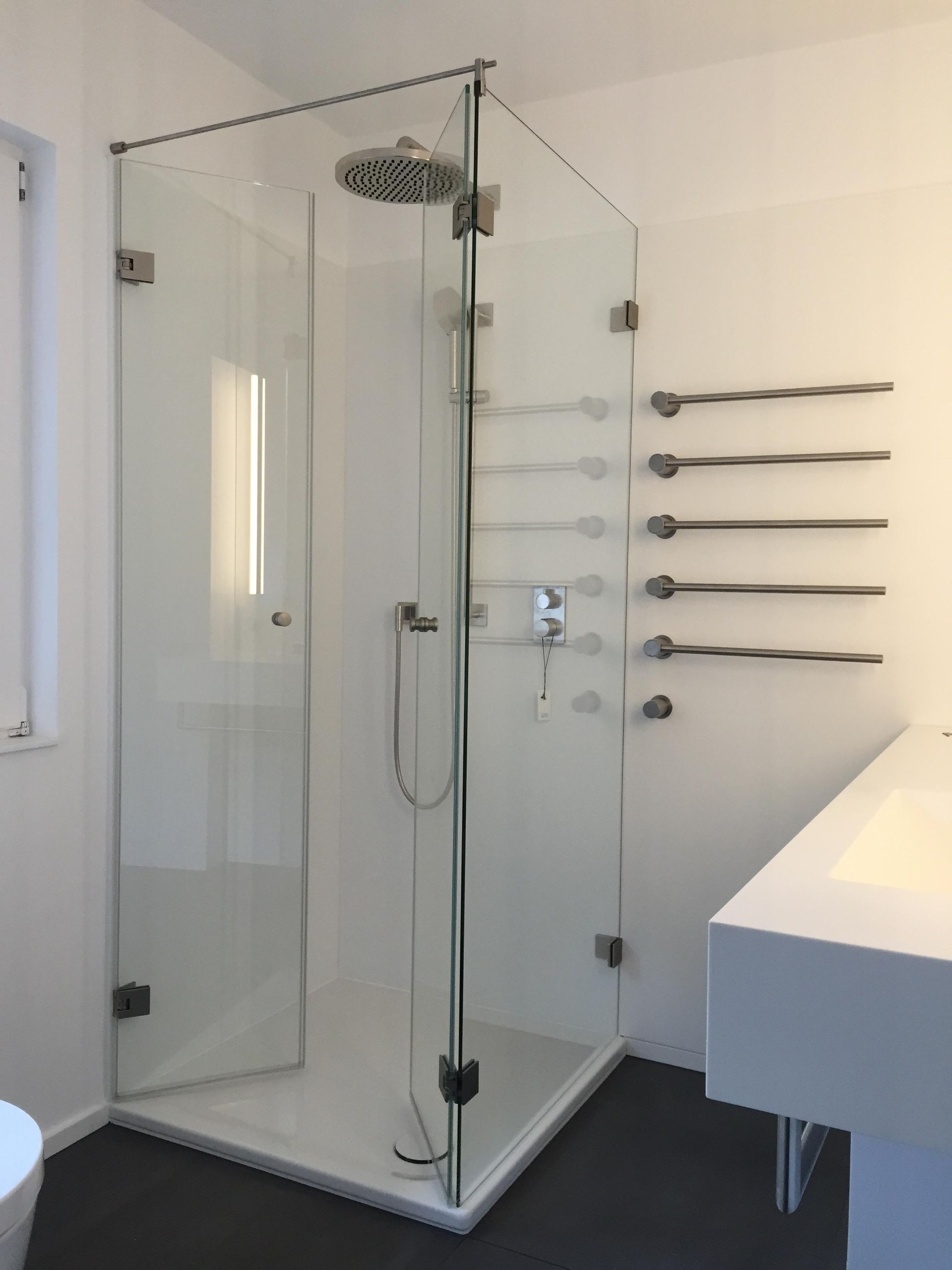 Ein Badezimmer mit ebenerdiger Dusche und Waschbecken