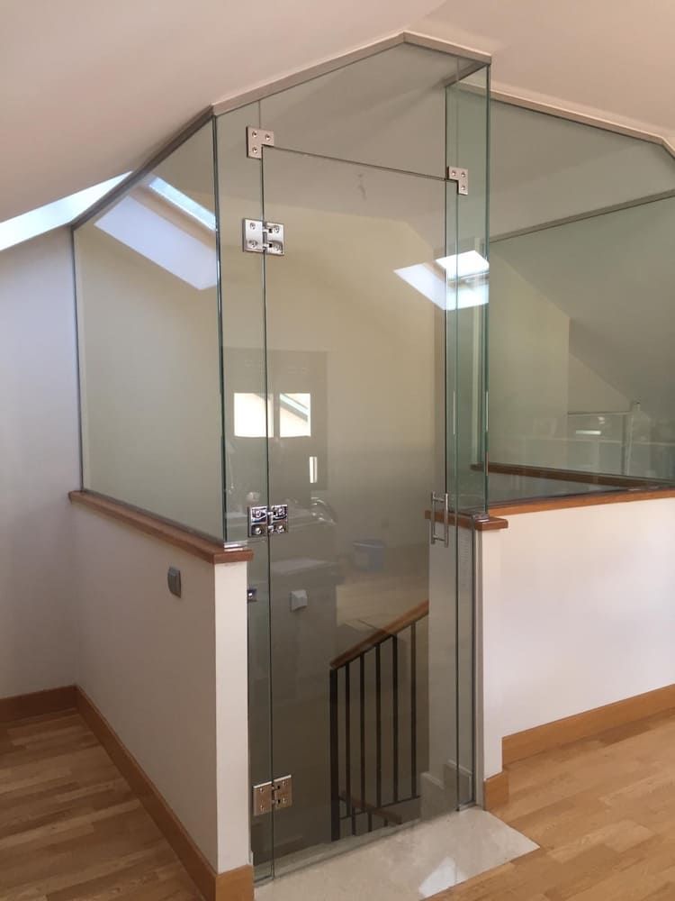 Una habitación con una puerta de cristal que conduce a una escalera.