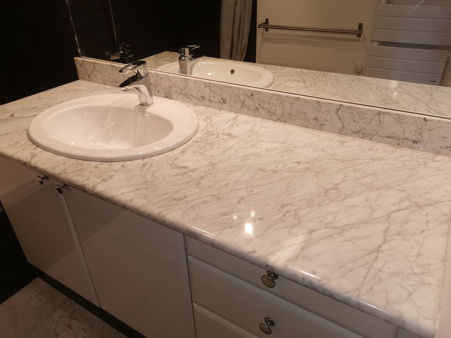 Un meuble de salle de bains en marbre blanc.