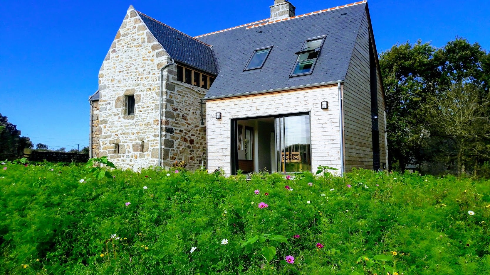 Maison en pierres apparentes avec un toit en ardoise