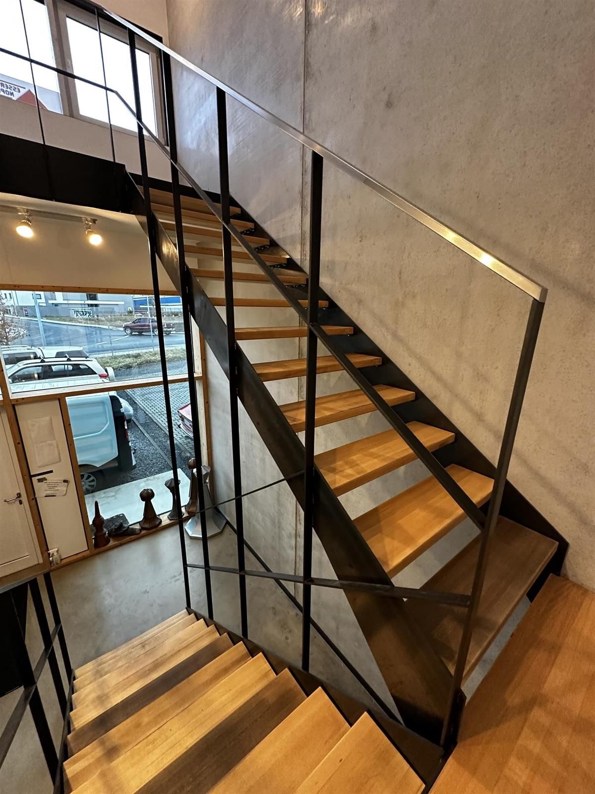 Eine Treppe mit Holzstufen und einem Glasgeländer