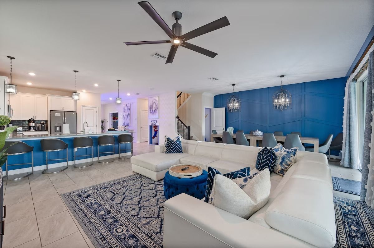 The front of a house with a lot of windows and a walkway leading to it.