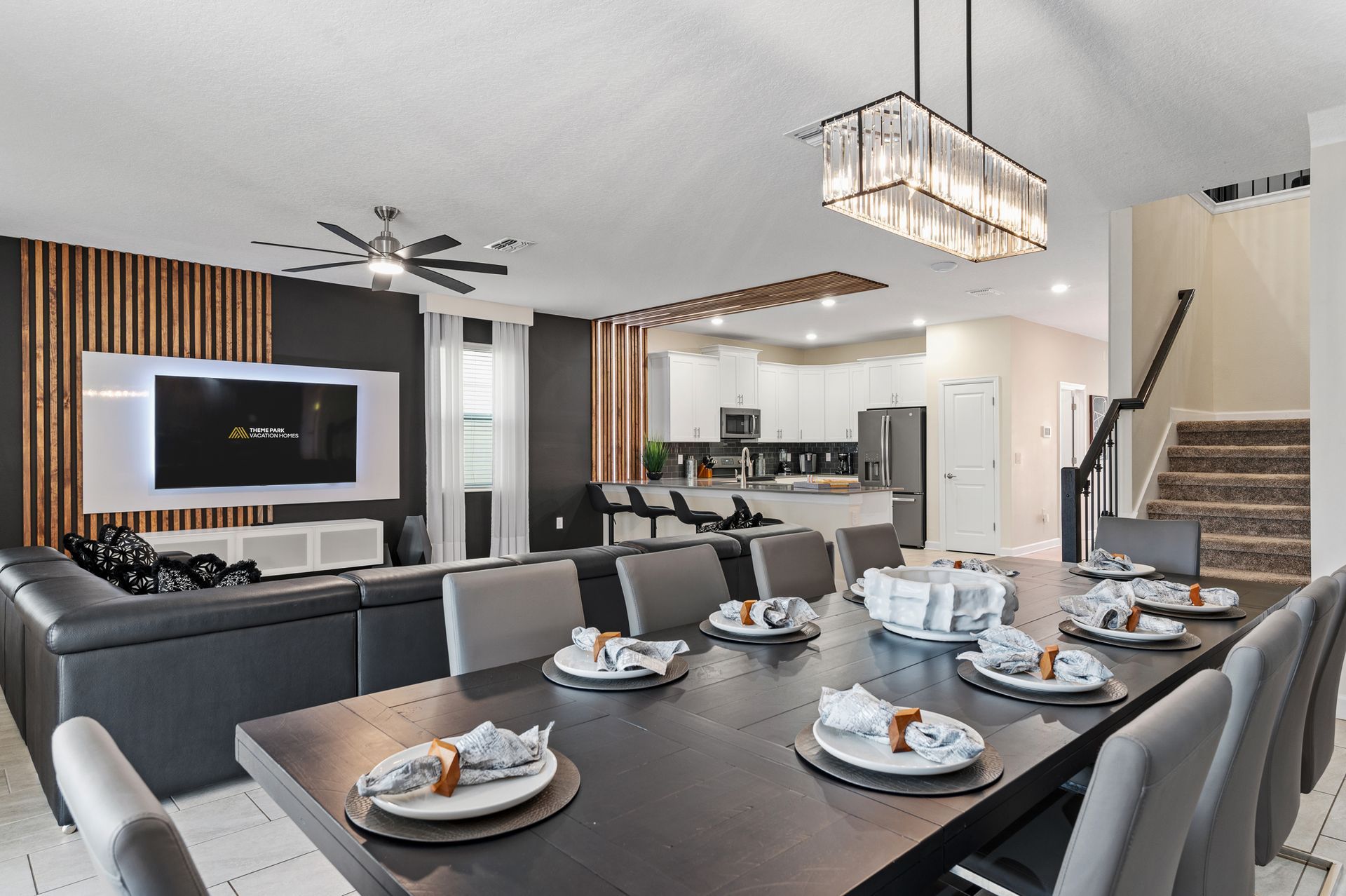 A dining room table with plates and napkins on it in a living room.