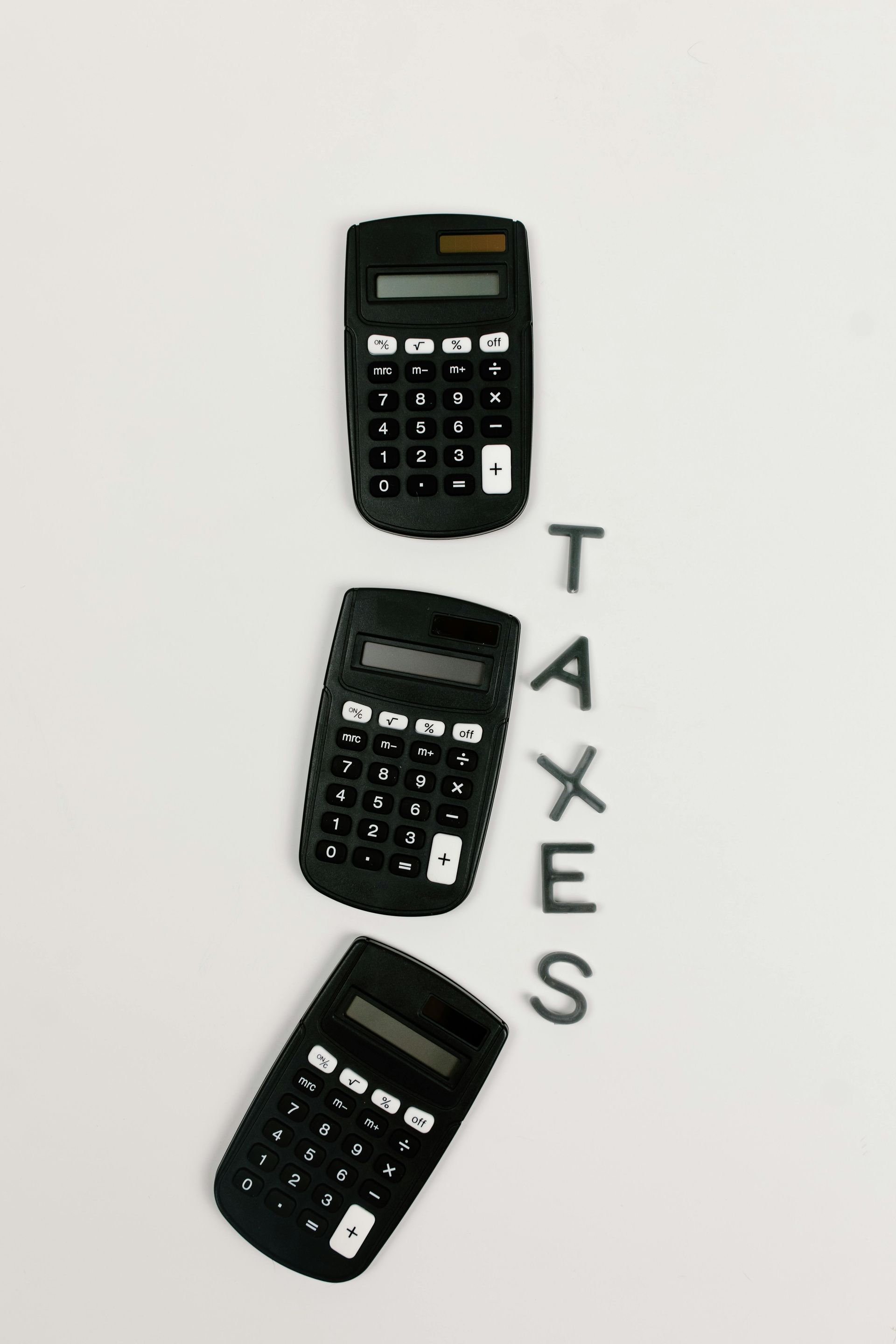 Three black calculators arranged vertically with the word