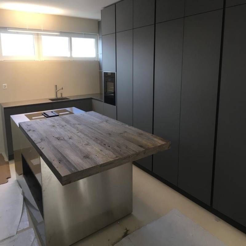 Una cucina con un grande tavolo di legno al centro