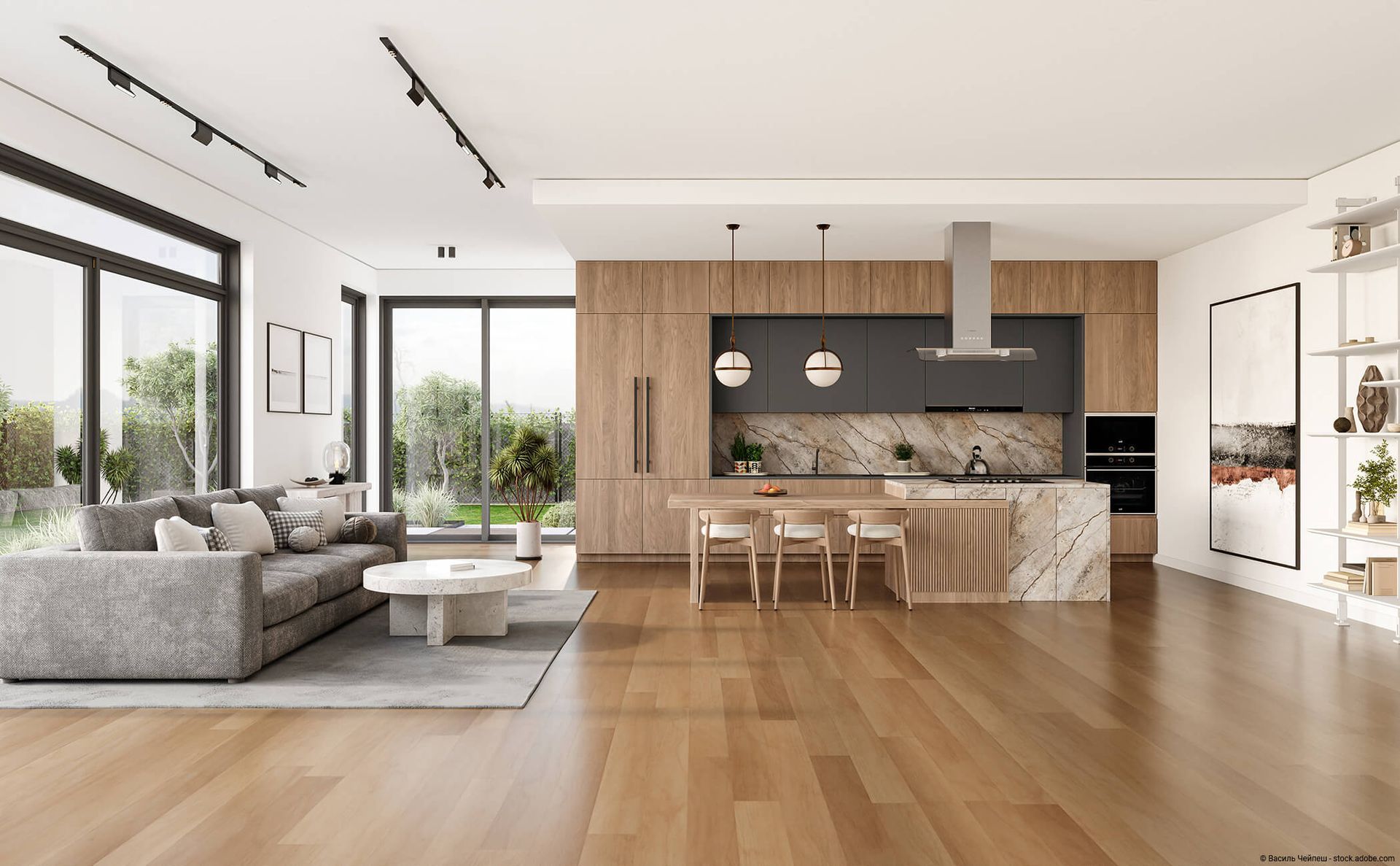 Ein moderner, offener Wohnbereich mit Holzschränken, einer Kücheninsel aus Marmor mit Barhockern und einem grauen Sofa.