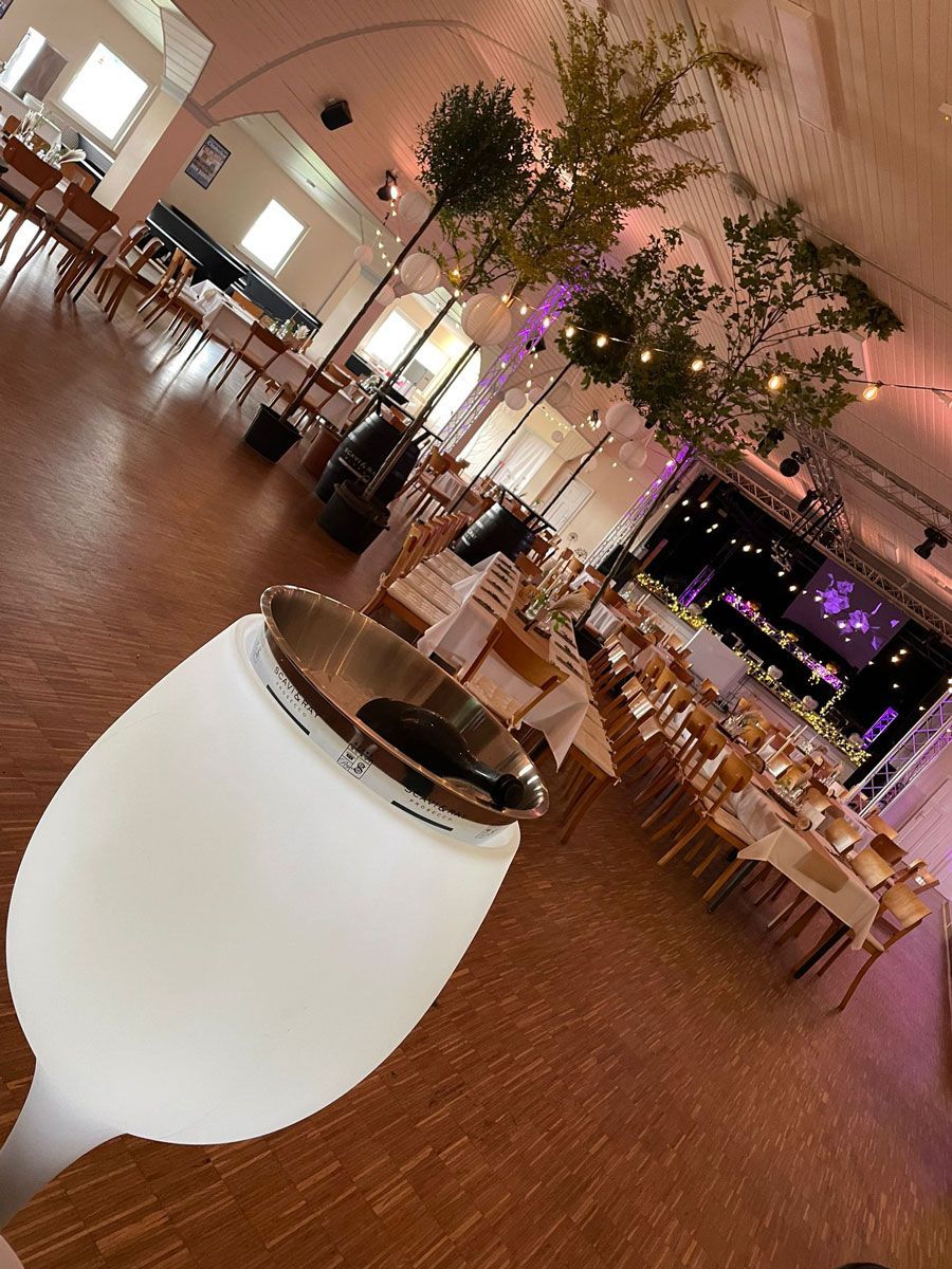 Ein Glas Weißwein steht auf einem Tisch in einem Restaurant.