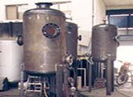 Un grupo de tanques de metal colocados uno al lado del otro en una fábrica.