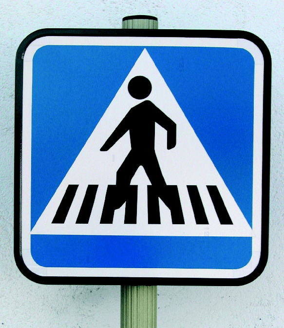 Señal de cruce de peatones de color azul y blanco con figura negra cruzando.