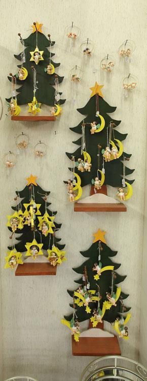 An einer Wand hängen drei kleine Weihnachtsbäume.