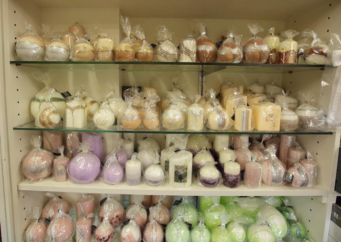 Ein Regal mit vielen verschiedenfarbigen Kerzen