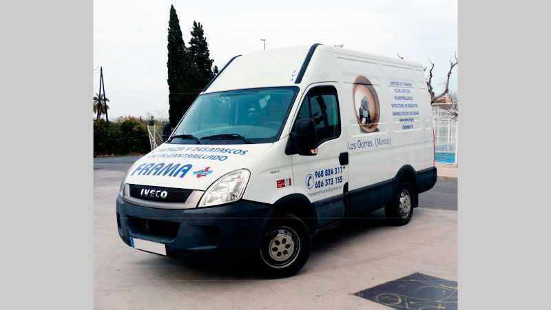Una camioneta blanca está estacionada en un estacionamiento.