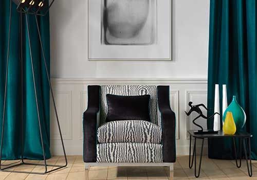 Ein Wohnzimmer mit Stuhl, Tisch, Lampe und Vasen.