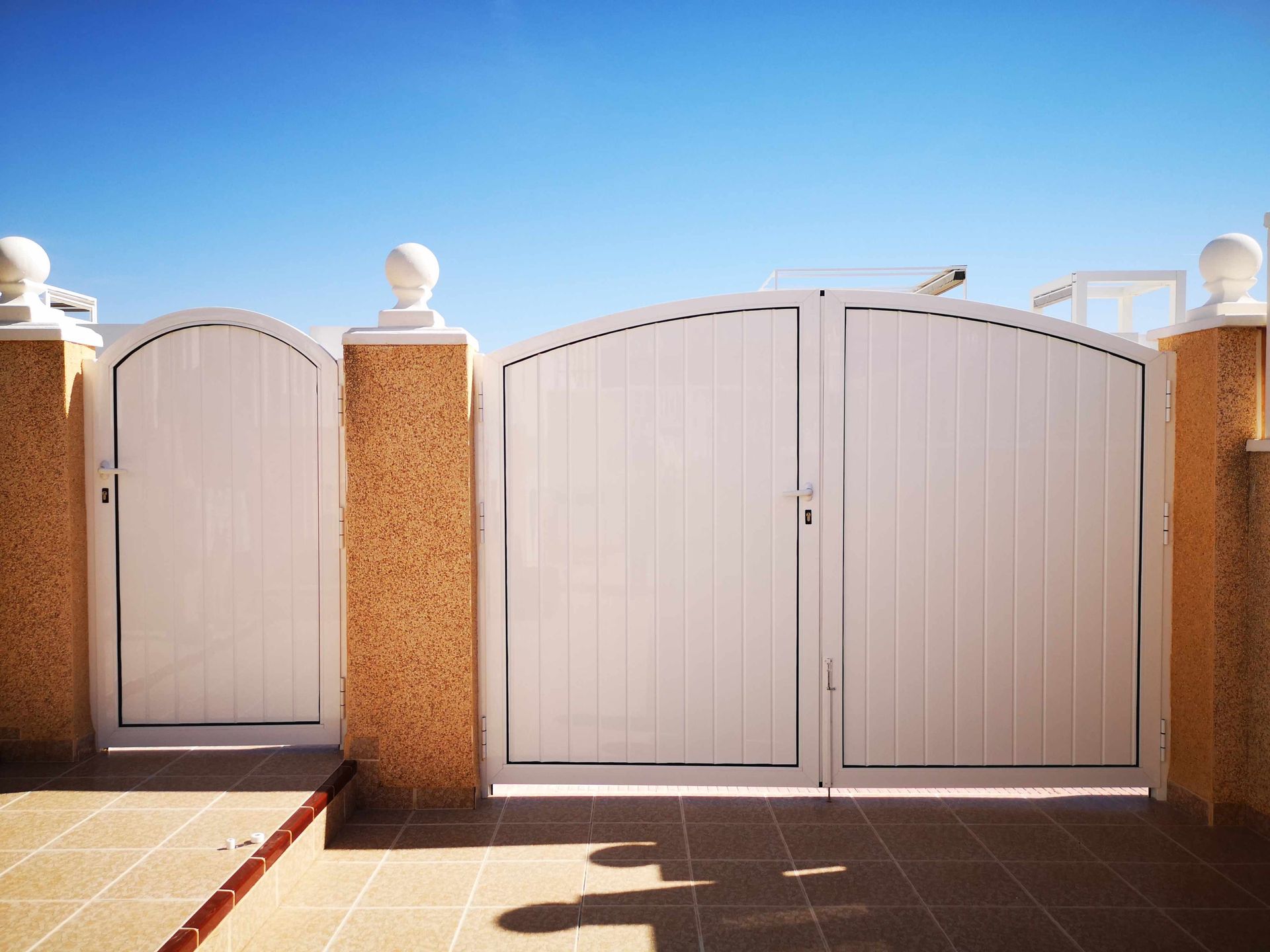 Una puerta blanca con un cielo azul al fondo