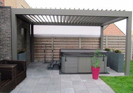 Un jacuzzi está debajo de una pérgola en un patio trasero.
