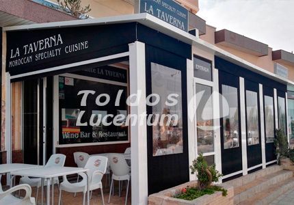 Un restaurante llamado La Taverna tiene mesas y sillas al aire libre.