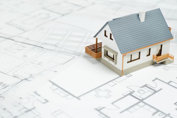Una casa modelo está colocada encima de un plano.