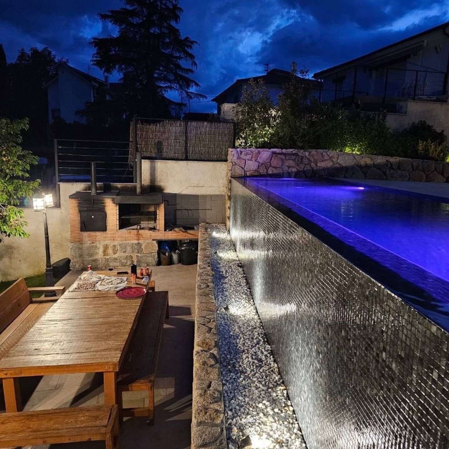 Una gran piscina está iluminada por la noche