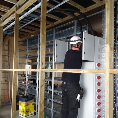 Electrician inspecting a fuse box