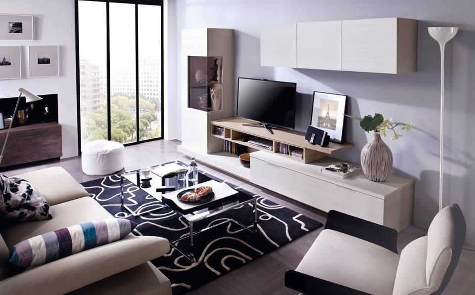 Sala de estar moderna con sofá color canela, alfombra negra, gabinetes blancos y ventana grande.