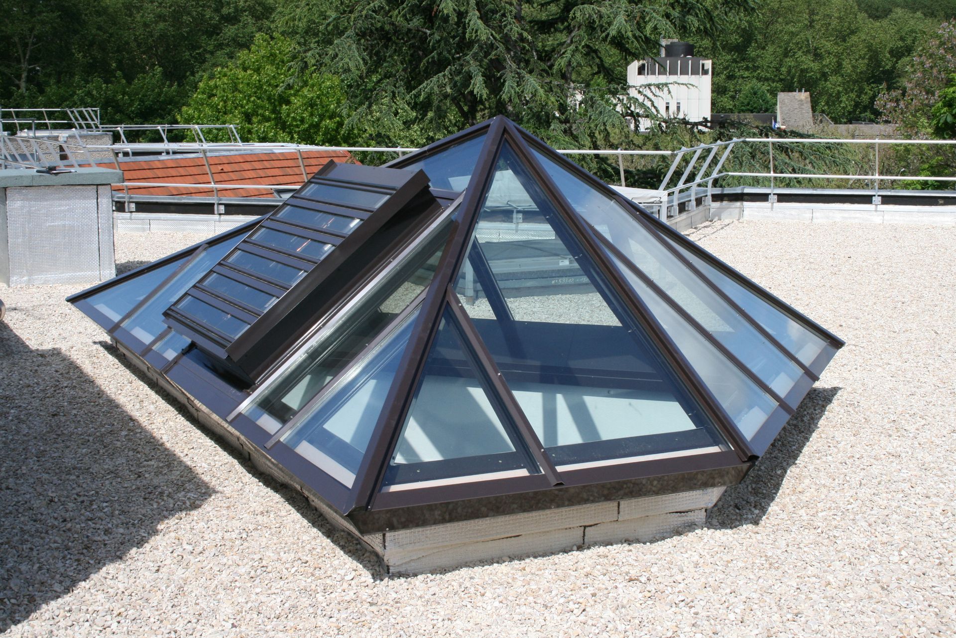 Puits de lumière en forme de pyramide sur un toit.