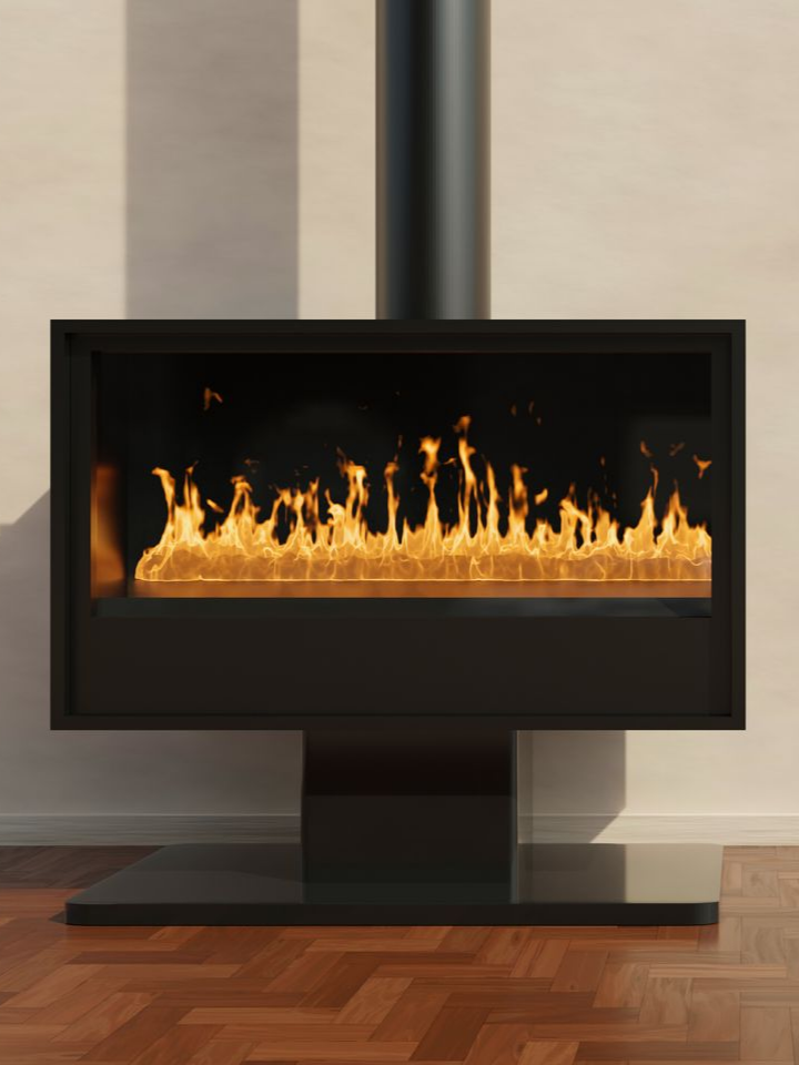 Cheminée noire avec flammes, conduit noir, sur un piédestal, contre un mur beige, sol en bois.
