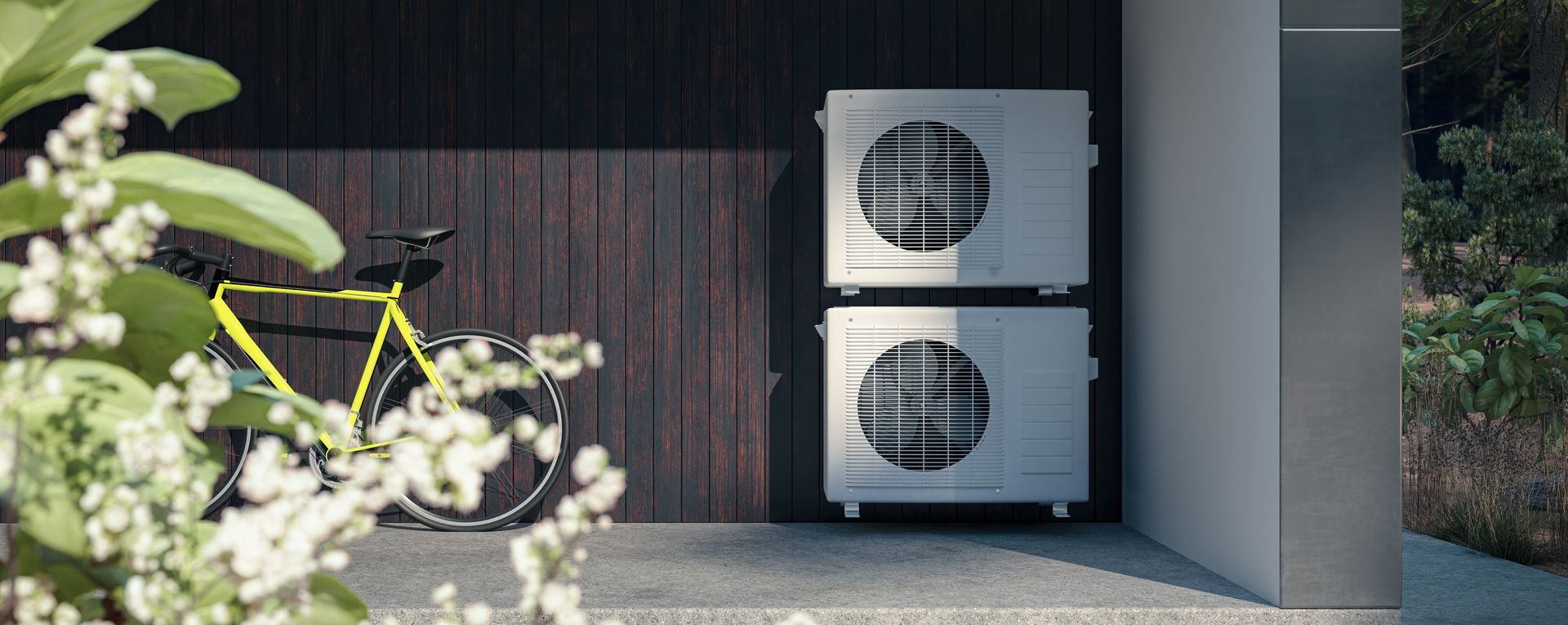 Deux unités de climatisation superposées à côté d'un vélo jaune.
