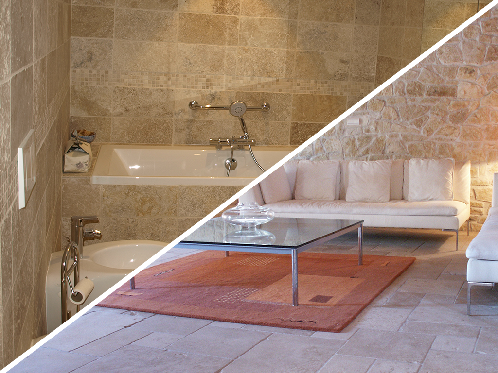 Vue en écran partagé : à gauche, une salle de bains carrelée en pierre avec une baignoire, et à droite, un espace de vie avec un canapé.